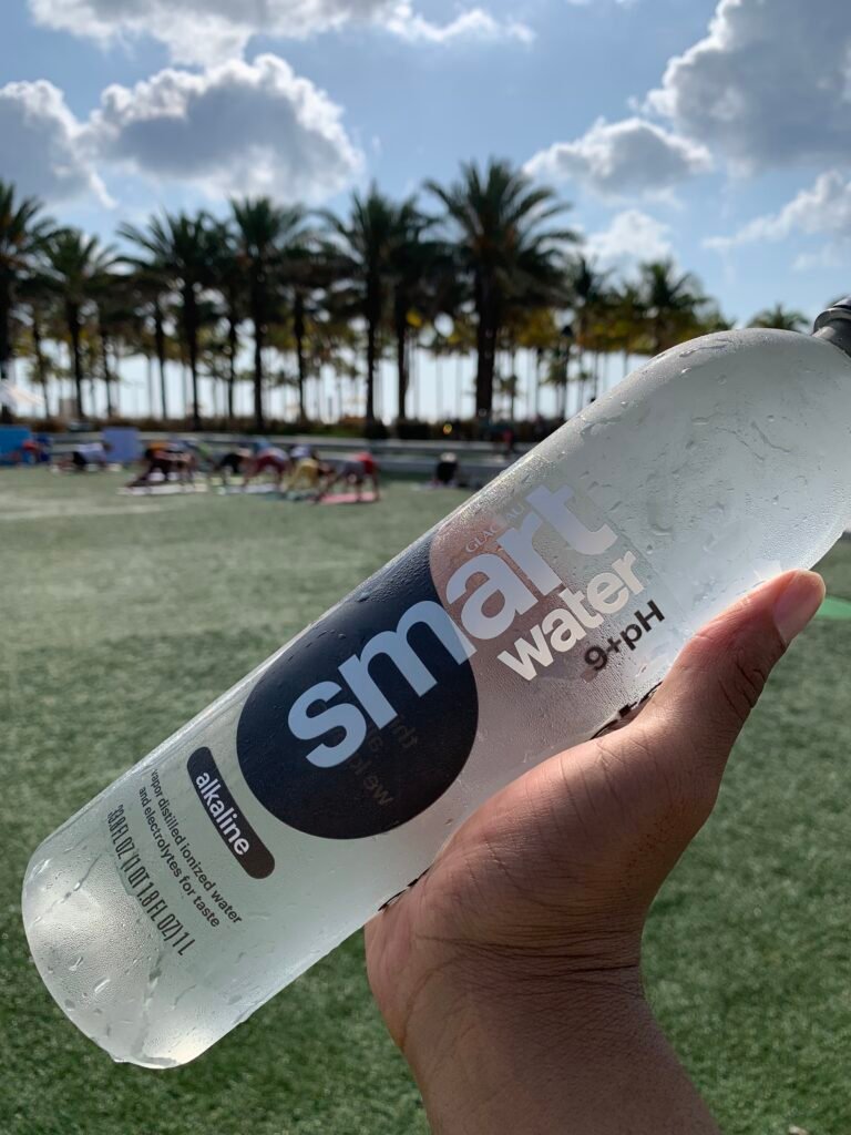 Hand holding Smartwater bottle.
